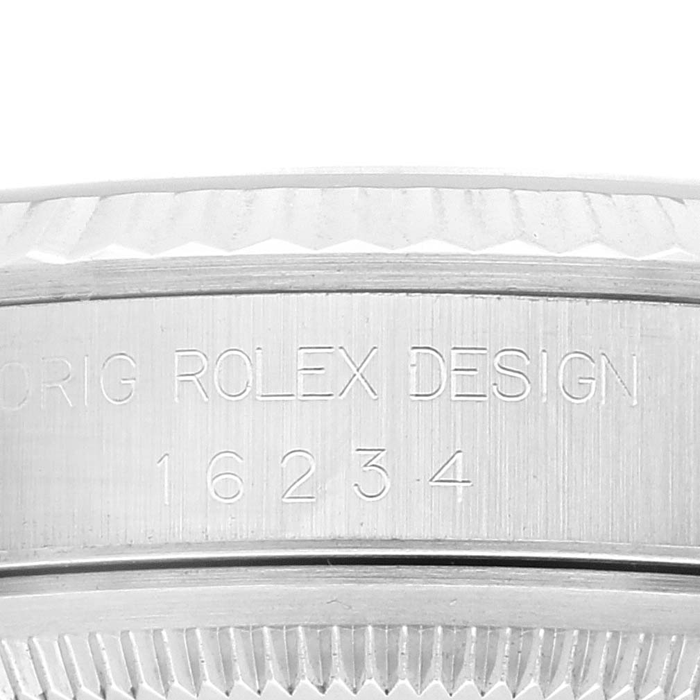 This image shows the engraved case side and bezel of a Rolex Datejust 16234 Men's Stainless Steel Pink Dial 16234 Men's Stainless Steel Pink Dial model.