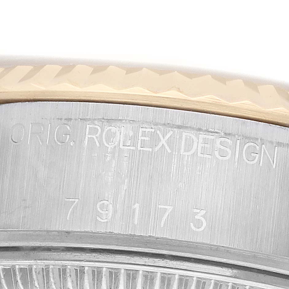 The image shows a close-up of the side of a Rolex Datejust 79173 Women
s Steel and Gold (two tone) Mother of Pearl Dial watch case, highlighting the model number and "Orig. Rolex Design" engraving.