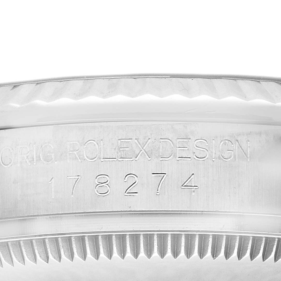 The image shows a close-up of the Rolex Datejust 178274 Women
s Stainless Steel Silver Dial case edge, revealing engraving details and part of the bezel.
