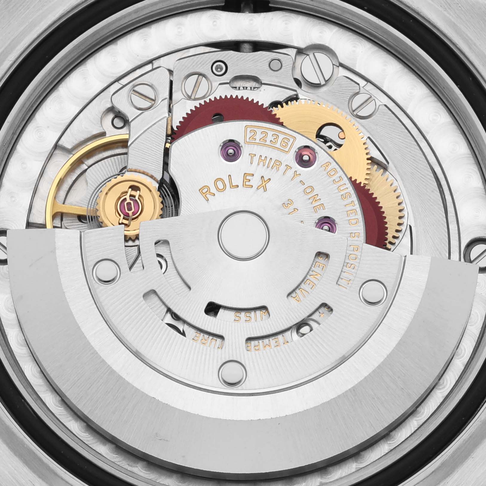The image shows the intricate internal mechanism of the Rolex Mid-Size 278241 Women's Steel and Gold (two tone) White Dial 278241 Women's Steel and Gold (two tone) White Dial model watch from a close-up angle, highlighting gears and components.