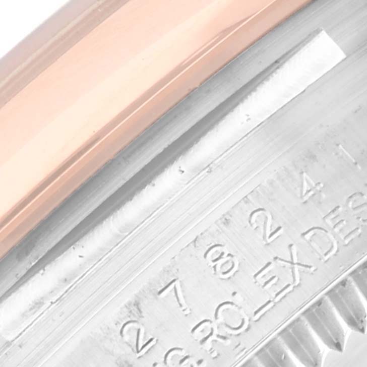 This close-up image of a Rolex Mid-Size 278241 Women's Steel and Gold (two tone) White Dial 278241 Women's Steel and Gold (two tone) White Dial watch shows part of the case and the engraved text on the inner bezel.