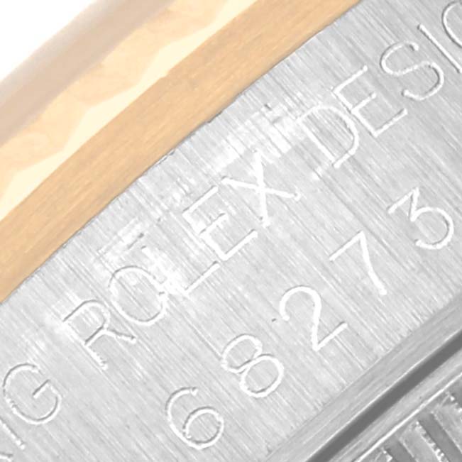 This close-up photo shows the bezel and case engraving of a Mid-Size Rolex watch, featuring the brand and design details.