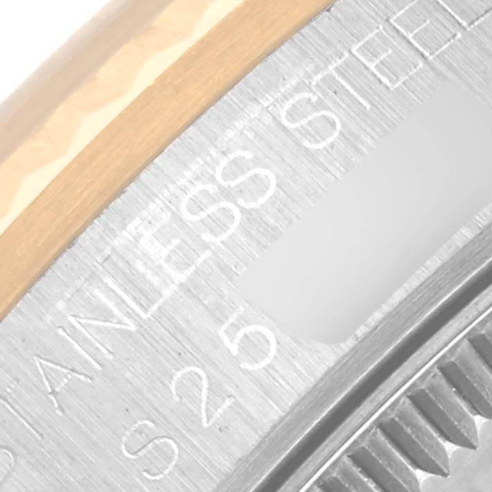 The image shows a close-up view of the side case and bezel of a Mid-Size Rolex watch, highlighting the "STAINLESS STEEL" engraving.