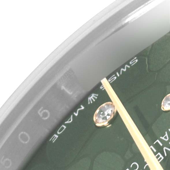 The image shows a close-up of the dial and hands of a Rolex Mid-Size 278243 Women's Steel and Gold (two tone) Green Dial 278243 Women's Steel and Gold (two tone) Green Dial watch, highlighting part of the "SWISS MADE" label.