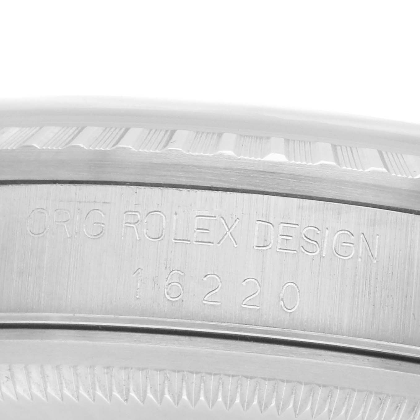 The image shows the side case engraving of a Rolex Datejust 16220 Men
s Stainless Steel Silver Dial, displaying the model number and design details.