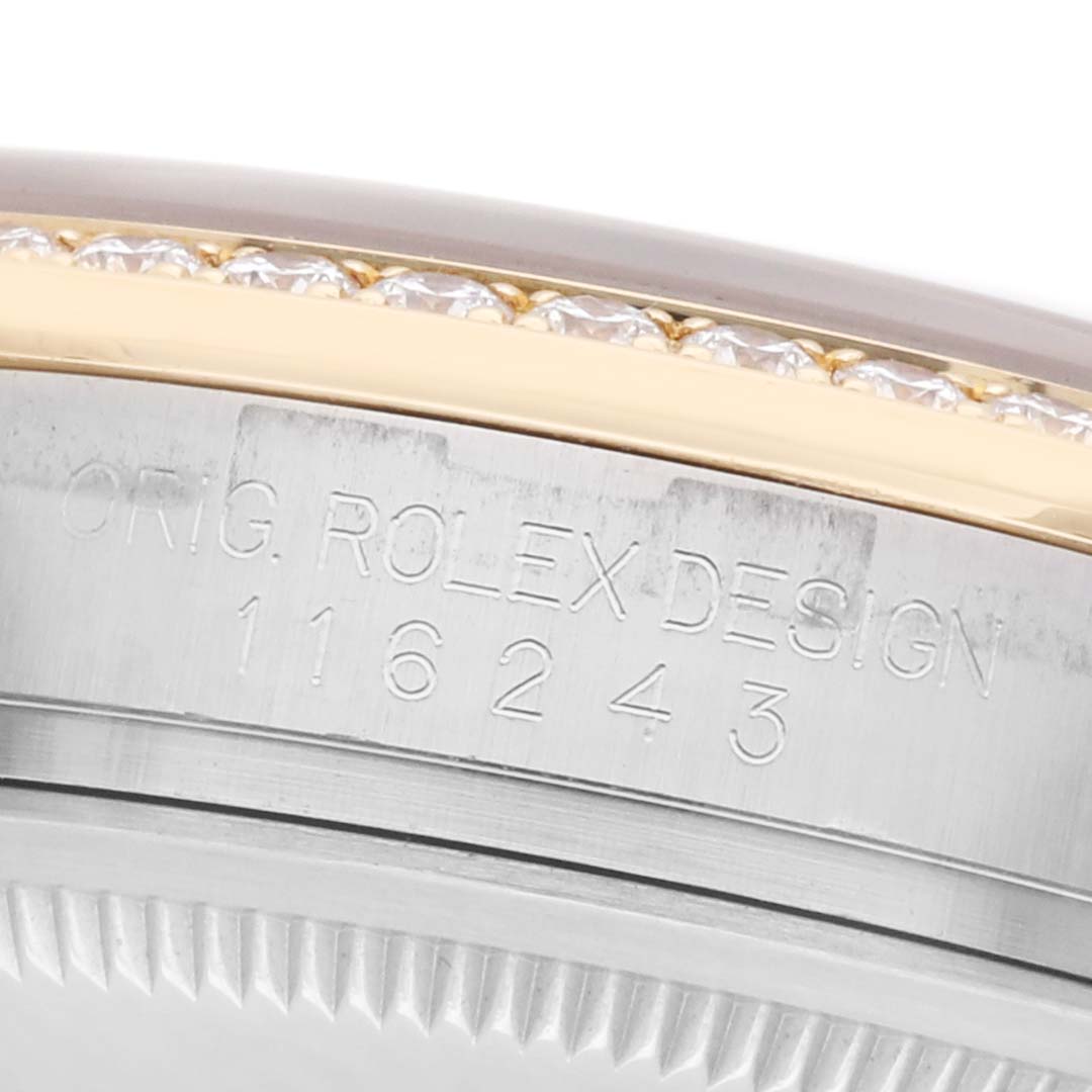 The image shows a close-up of the side of a Rolex Datejust 116243 Men
s Steel and Gold (two tone) Silver Dial, highlighting the engraved model number and part of the bezel.