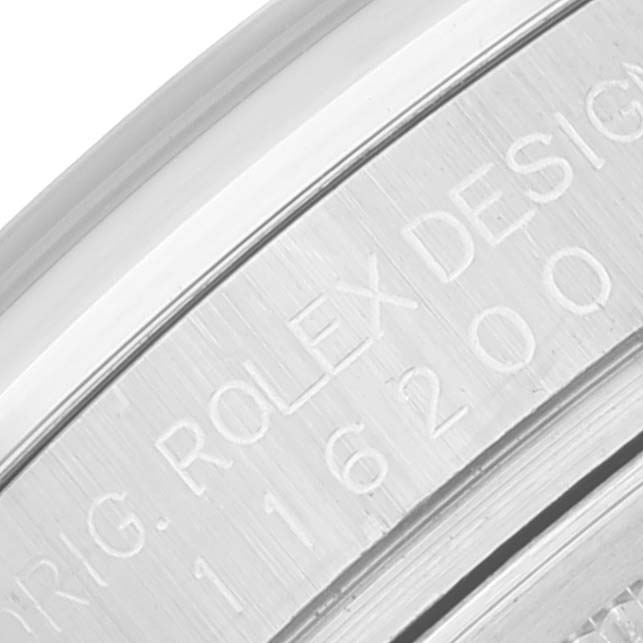This close-up image shows the engraved text on the outer rim of a Rolex Datejust 116200 Men's Stainless Steel Silver Dial 116200 Men's Stainless Steel Silver Dial model.