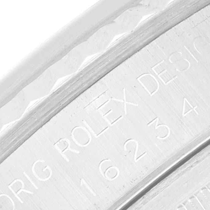 The image shows a close-up of the engraved inner bezel of a Rolex Datejust 16234 Men's Stainless Steel Silver Dial 16234 Men's Stainless Steel Silver Dial watch.