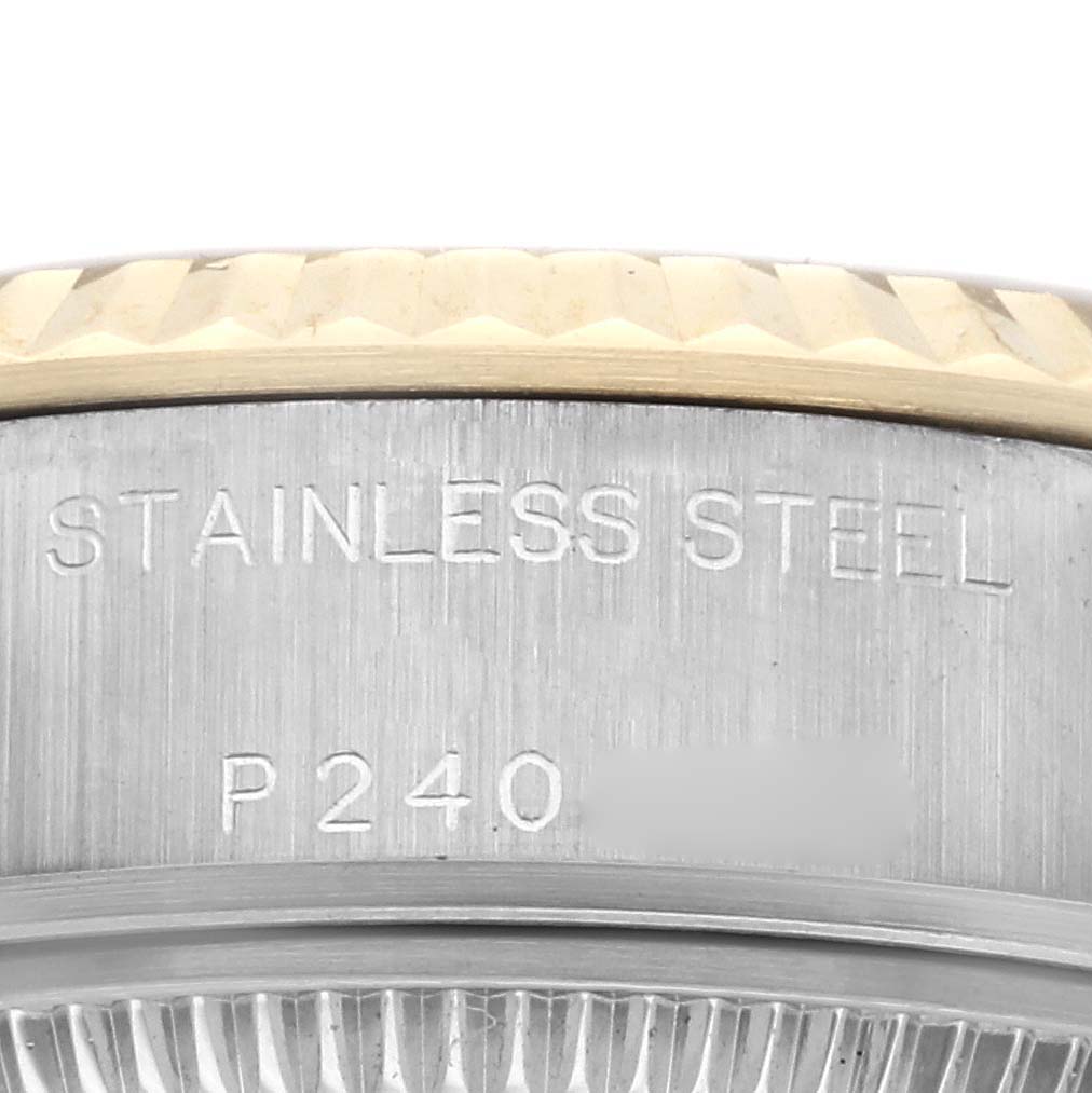 The image shows a close-up of the case back edge of a Rolex Datejust 79173 Women
s Steel and Gold (two tone) Champagne Dial 79173 Women
s Steel and Gold (two tone) Champagne Dial watch, highlighting its stainless steel material and serial number.