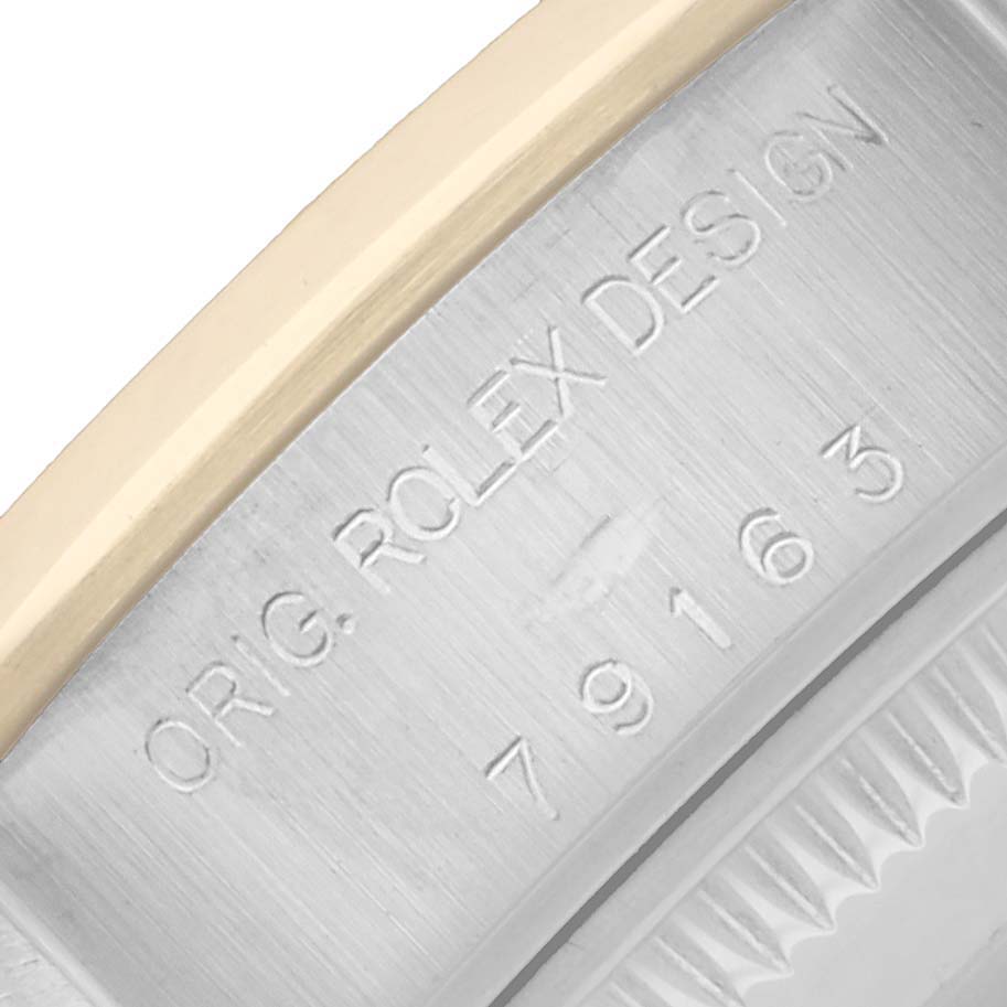 The image shows a close-up of the side of a Rolex Datejust 79163 Women
s Steel and Gold (two tone) Champagne Dial watch, highlighting the engraved model and design details.