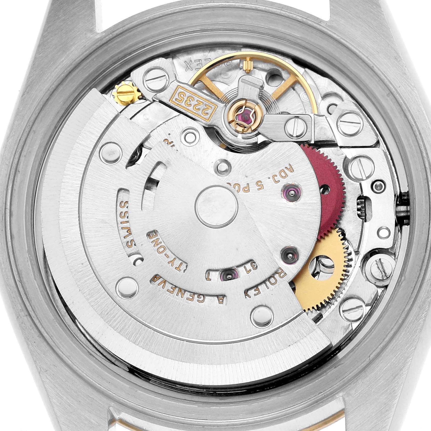 The image shows the movement mechanism of a Rolex Datejust 79163 Women
s Steel and Gold (two tone) Champagne Dial watch from a back view, highlighting gears and the rotor.