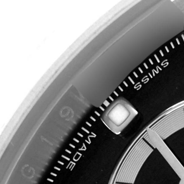 This close-up photo of the Rolex Daytona 116520 Men's Stainless Steel Black Dial 116520 Men's Stainless Steel Black Dial watch shows part of the dial at an angle, highlighting the "Swiss Made" text.