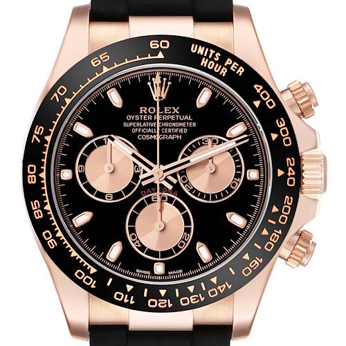 The image shows a front view of a Rolex Daytona watch, highlighting its black dial, chronograph subdials, and gold bezel.