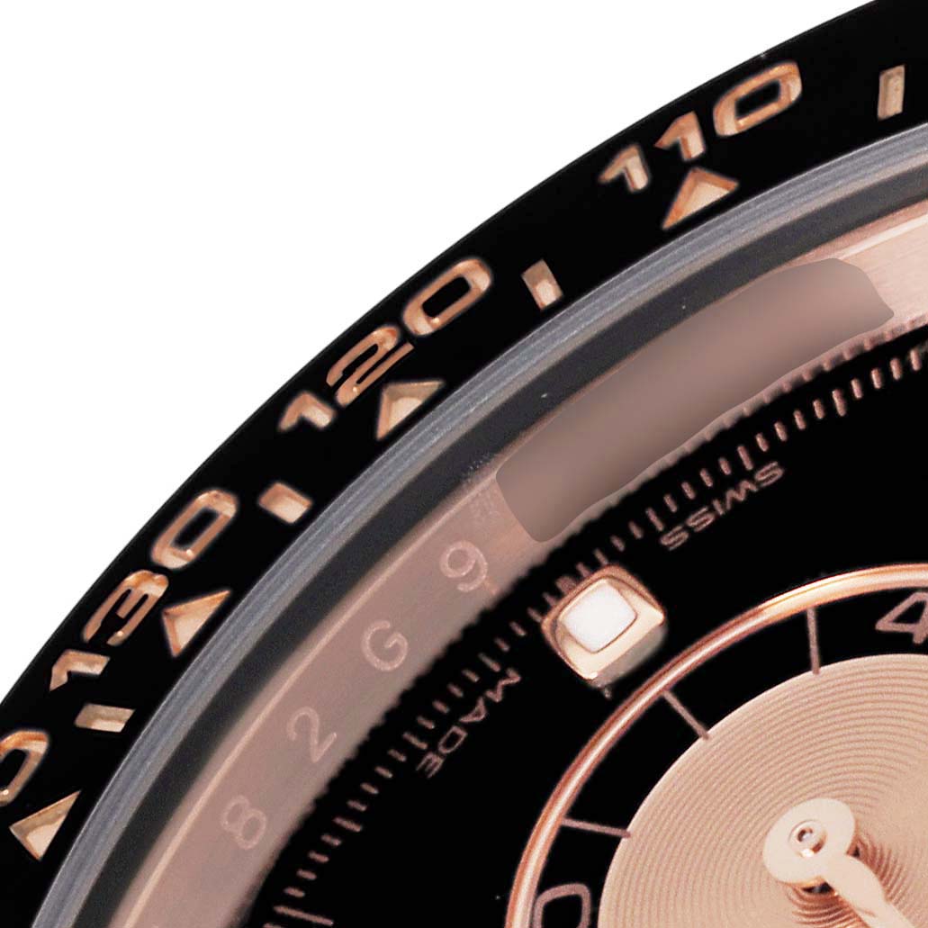 This close-up image of the Rolex Daytona 116515 Men's Rose Gold Black Dial 116515 Men's Rose Gold Black Dial watch shows part of the bezel with numeric markings and a portion of the dial.