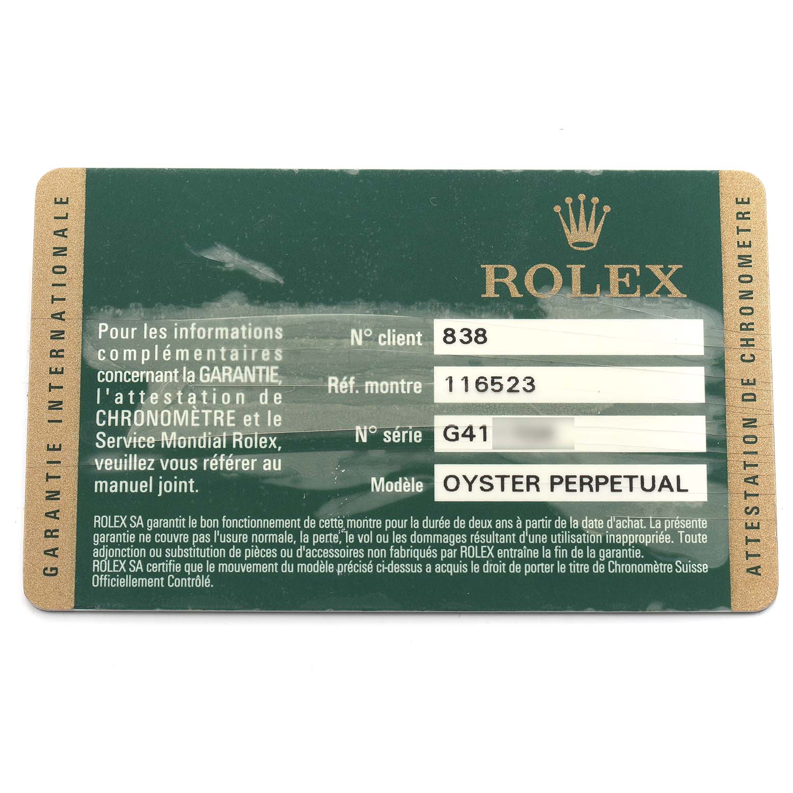 The image shows a warranty card for a Rolex Daytona 116523 Men
s Steel and Gold (two tone) Mother of Pearl Dial model, detailing reference, serial number, and model name.
