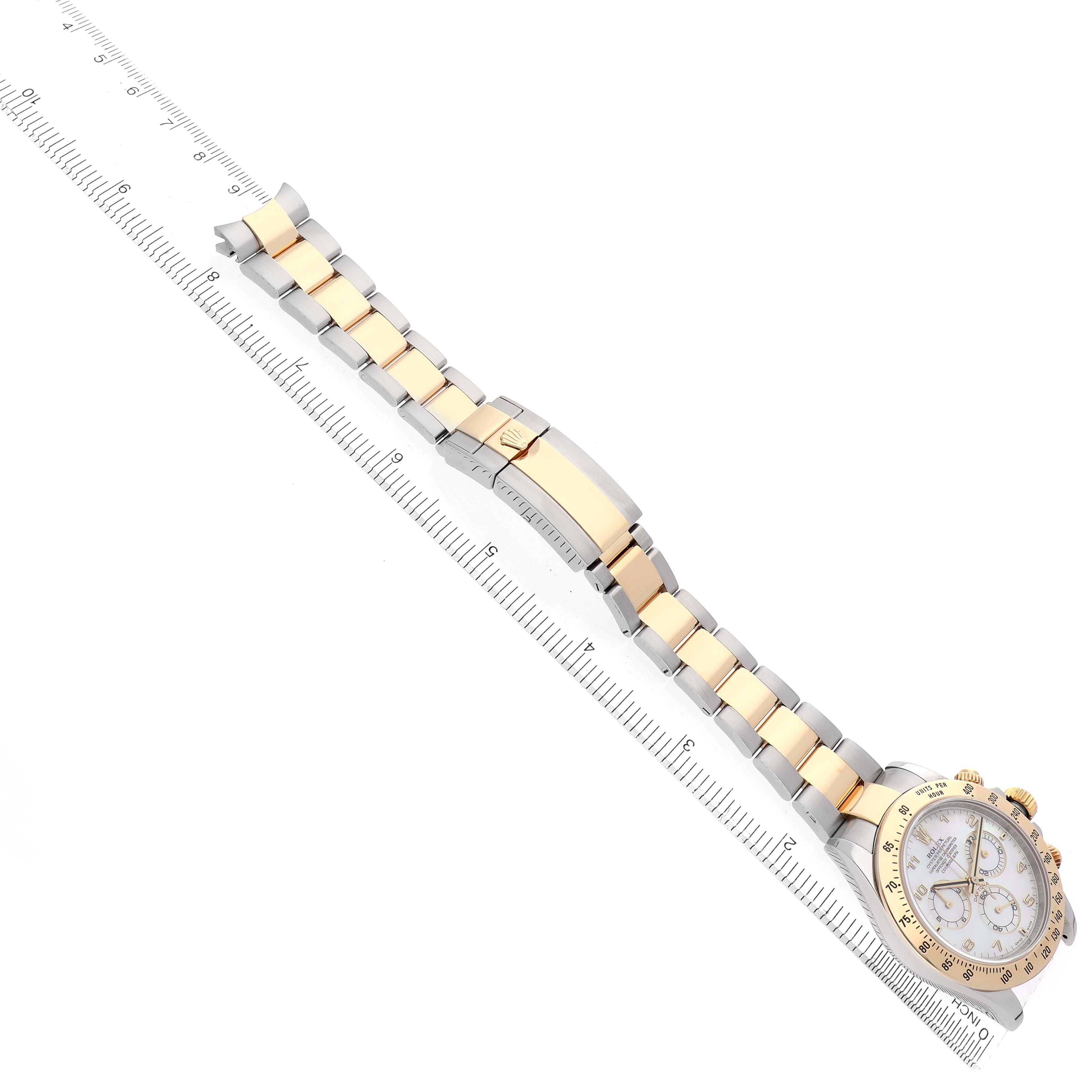 The Rolex Daytona 116523 Men
s Steel and Gold (two tone) Mother of Pearl Dial watch is shown sideways with the full bracelet, clasp, and part of the bezel and dial visible.