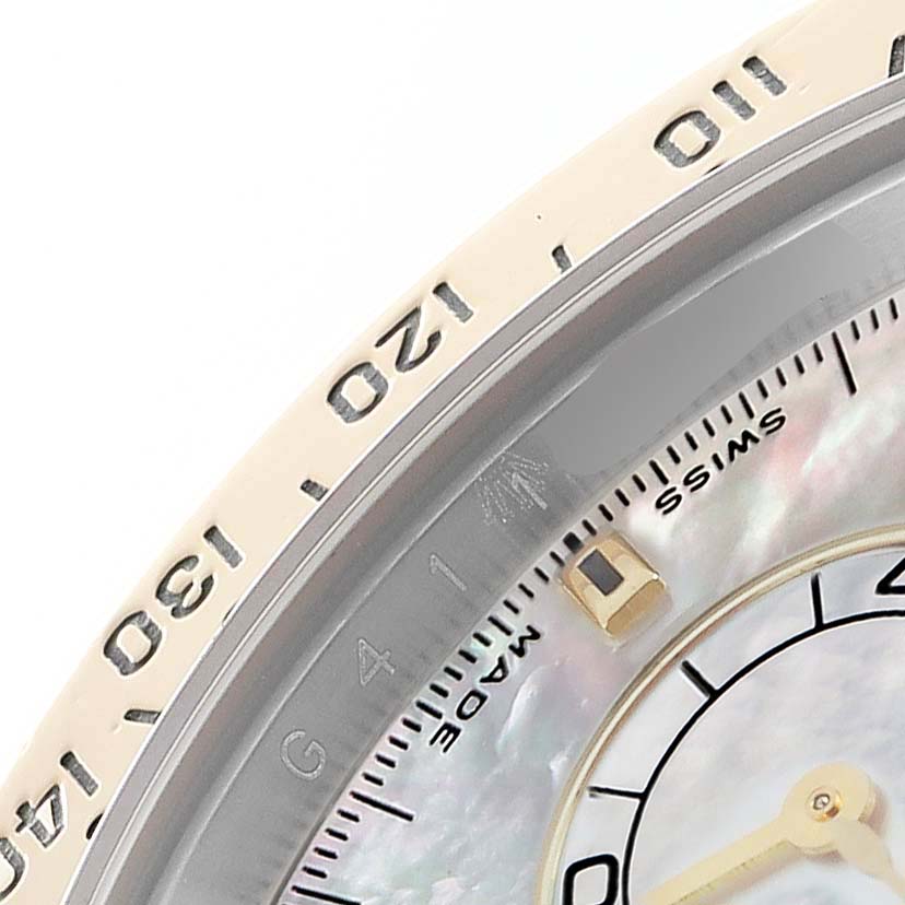 The image shows a close-up of the bezel and part of the dial of a Rolex Daytona 116523 Men
s Steel and Gold (two tone) Mother of Pearl Dial watch.