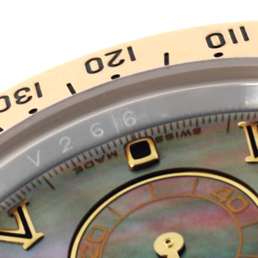 The image shows a close-up near the bezel and part of the dial of the Rolex Daytona 116523 Men's Steel and Gold (two tone) Mother of Pearl Dial 116523 Men's Steel and Gold (two tone) Mother of Pearl Dial watch.