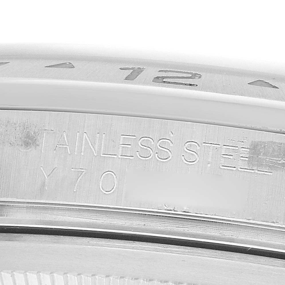 The image shows a close-up of the stainless steel casing with engraved details on the Rolex Explorer 16570 Men
s Stainless Steel Black Dial watch.