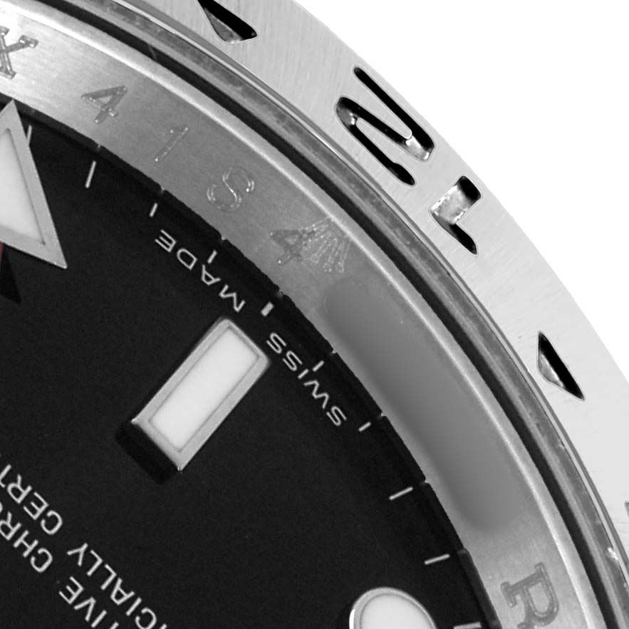 The image shows a close-up of the Rolex Explorer 16570 Men
s Stainless Steel Black Dial
s bezel, partial dial, and hour marker at an angle.