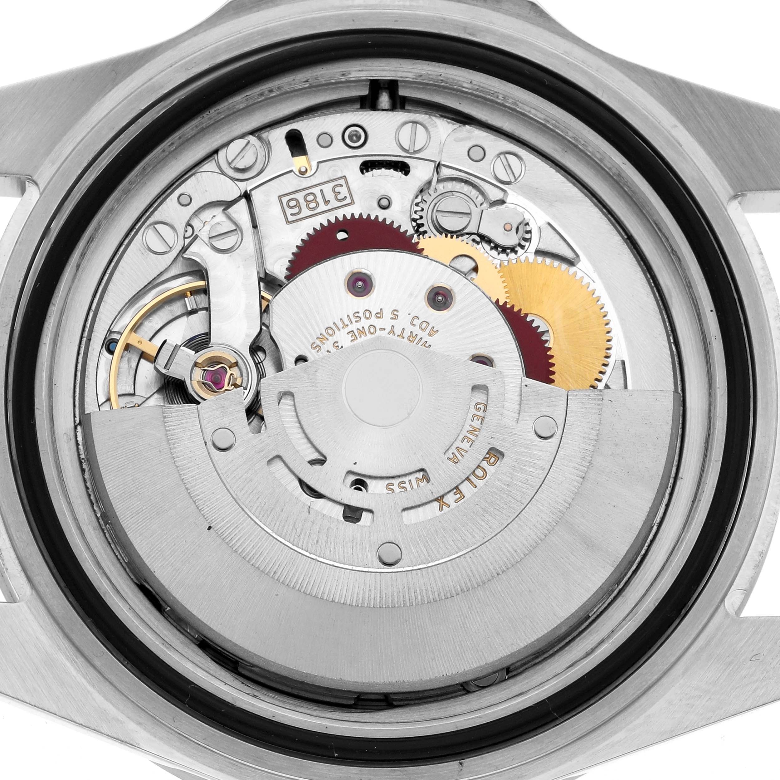The image shows the movement mechanism of a Rolex Explorer 16570 Men
s Stainless Steel Black Dial watch from the back, revealing gears and components.