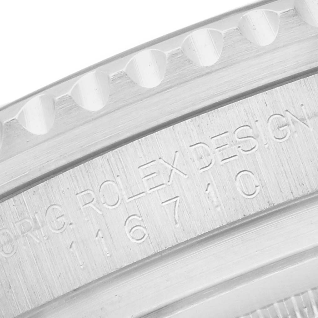 The image shows a close-up of the case engraving on a Rolex GMT-Master 116710 Men
s Stainless Steel Black Dial, displaying "ROLEX DESIGN" and reference number.