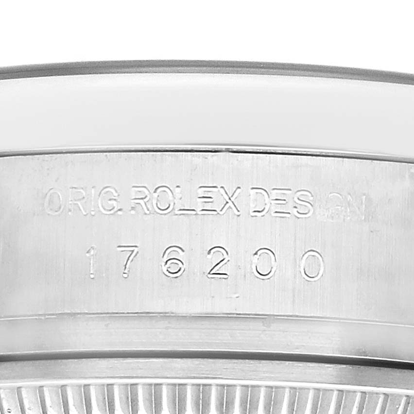 The image shows a close-up of the side of a Rolex Oyster Perpetual 176200 Women
s Stainless Steel Black Dial watch, highlighting the model number engraving.