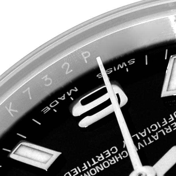 The image shows a close-up of the dial and bezel edge of a Rolex Oyster Perpetual 176200 Women
s Stainless Steel Black Dial watch, highlighting hour markers and text.