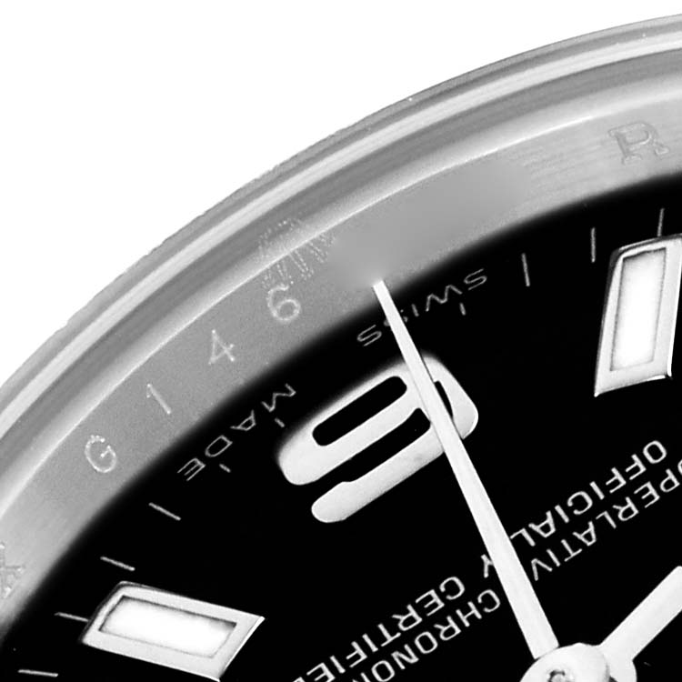 The image shows a close-up of the Rolex Oyster Perpetual 176200 Women
s Stainless Steel Black Dial’s dial, focusing on the number 9, hour markers, and partial text.