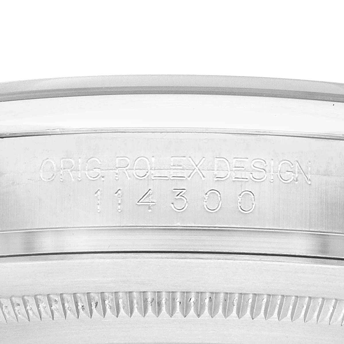 The image shows a close-up of the side of a Rolex Oyster Perpetual 114300 Men
s Stainless Steel Blue Dial watch, highlighting its model number engraving.