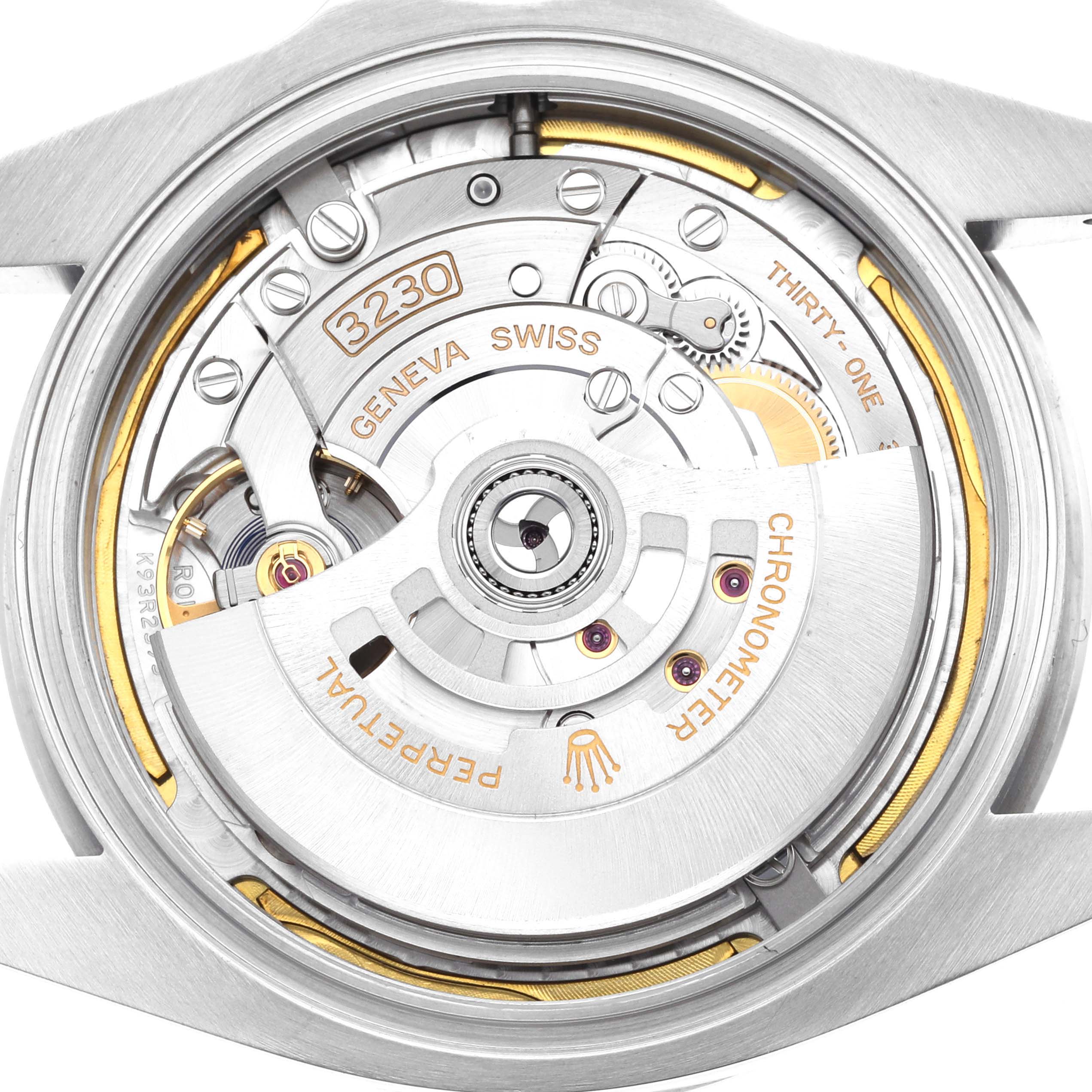 The image shows a close-up of the movement mechanism of the Rolex Air-King 126900 Men
s Stainless Steel Black Dial watch, highlighting the rotor and detailed engravings.