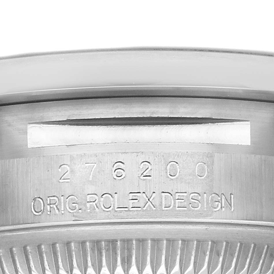 The image shows a close-up of the case back and edge engraving on a Rolex Oyster Perpetual 276200 Women
s Stainless Steel Blue Dial watch.