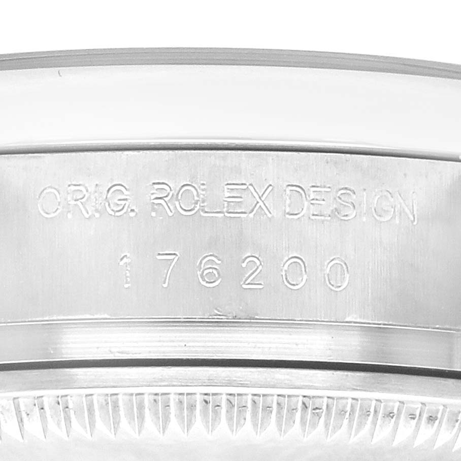 The image shows a close-up view of the Oyster Perpetual Rolex watch
s side, featuring the engraving "ORIG. ROLEX DESIGN 176200".
