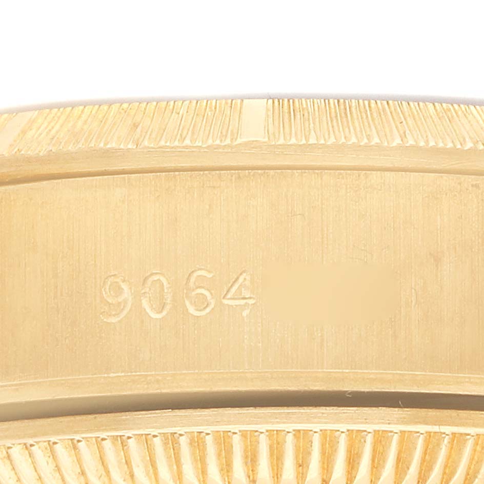 The image shows the side view of a Rolex President 69278 Women
s Yellow Gold Champagne Dial model, focusing on the engraved serial number on its case.