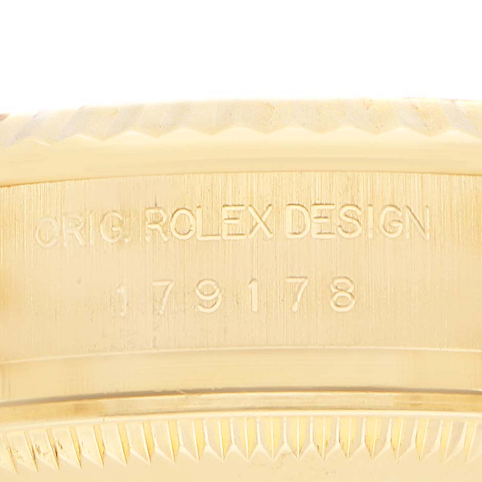 The image shows a close-up of the engraving on the case side of the Rolex President 179178 Women
s Yellow Gold Champagne Dial model, highlighting "ORIG. ROLEX DESIGN" and numbers.