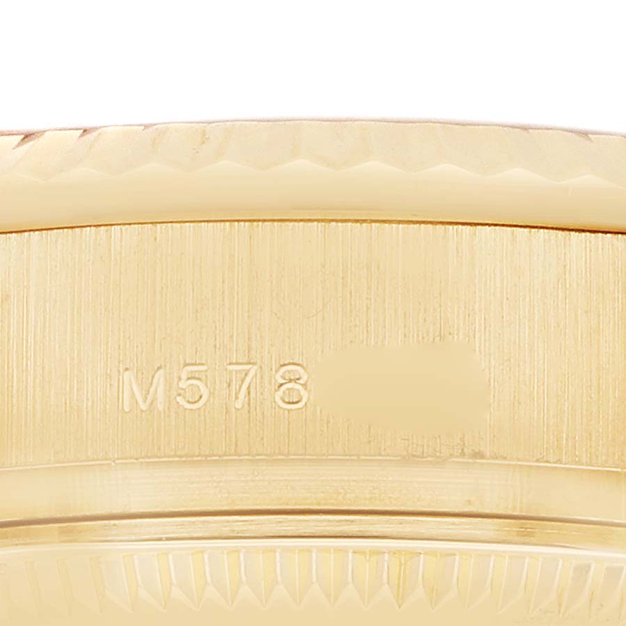 The image shows a close-up of the side of a Rolex President 179178 Women
s Yellow Gold Champagne Dial watch case with engraved reference numbers.