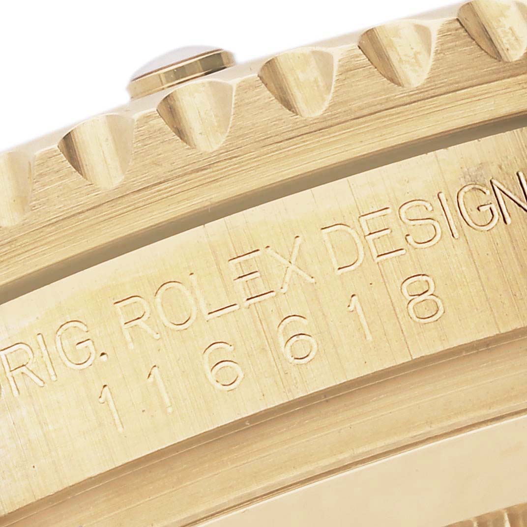 This close-up image shows the engraving on the case side and part of the bezel of the Rolex Submariner 116618 Men
s Yellow Gold Black Dial 116618 Men
s Yellow Gold Black Dial model 116618.
