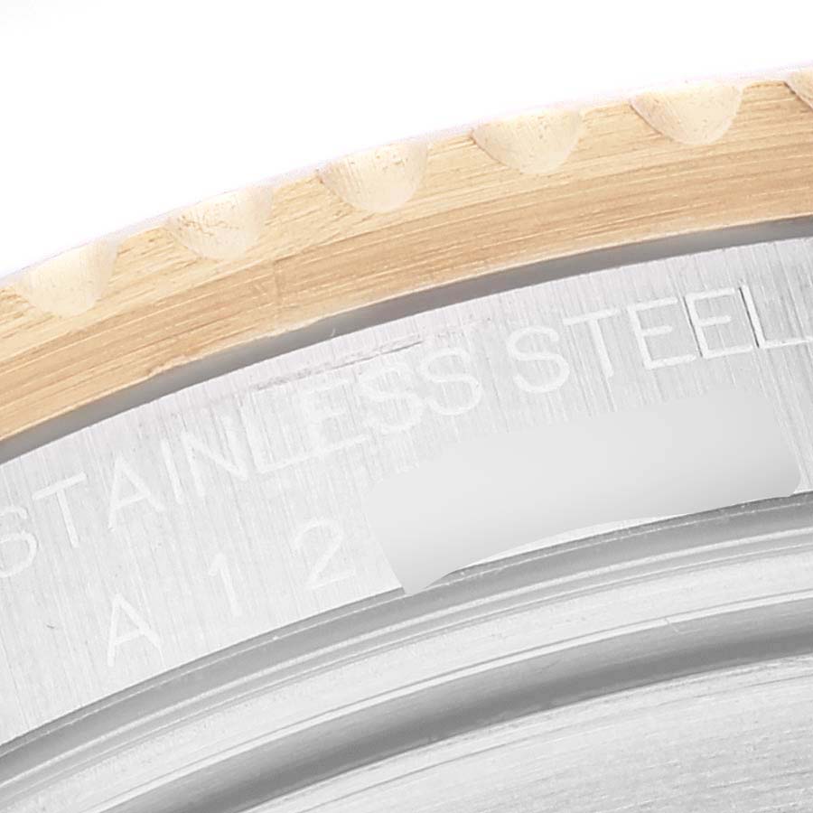 This close-up image shows the stainless steel bezel edge and engravings on a Rolex Submariner 16613 Men's Steel and Gold (two tone) Blue Dial 16613 Men's Steel and Gold (two tone) Blue Dial watch.