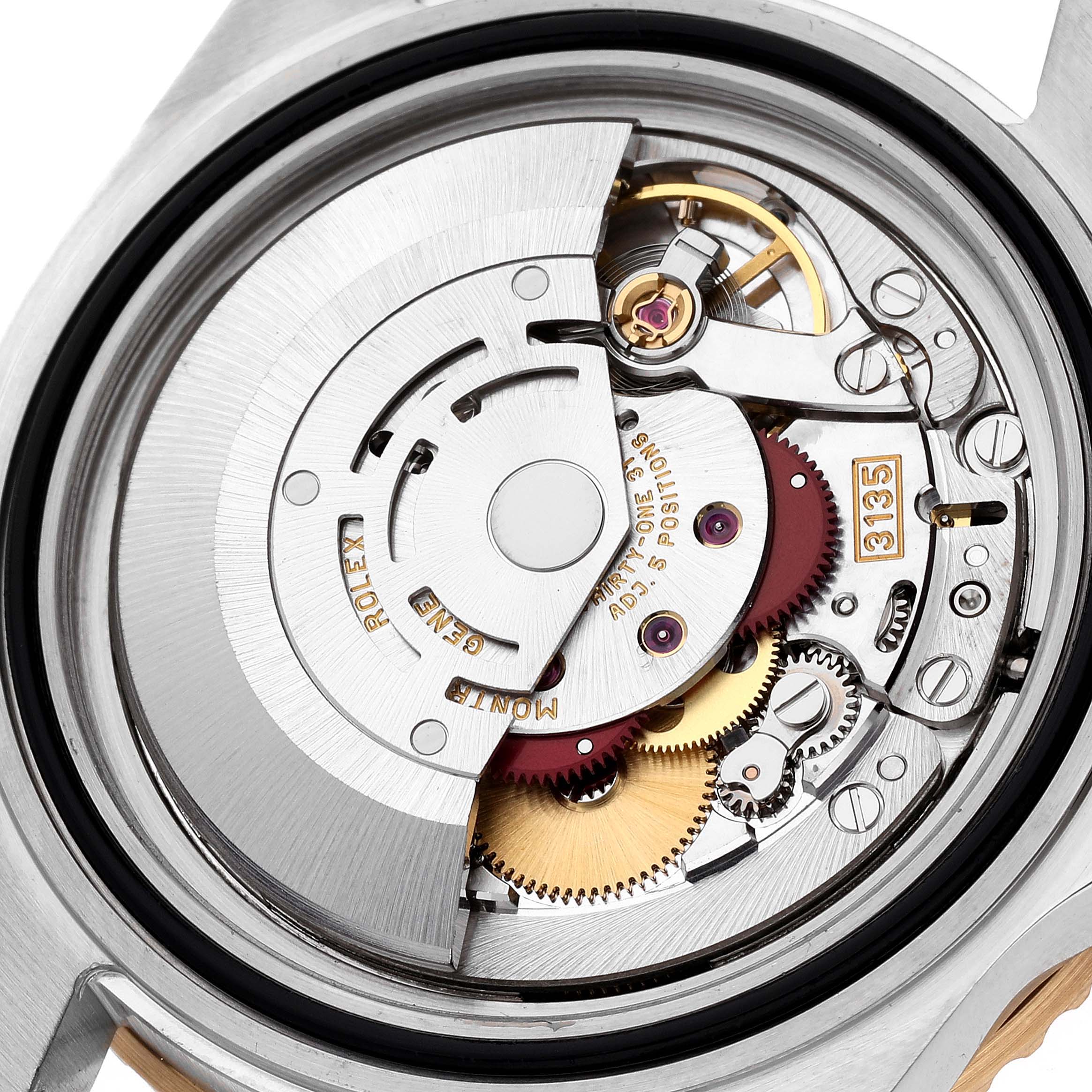 This image shows an angled view of the Rolex Submariner 16613 Men's Steel and Gold (two tone) Blue Dial 16613 Men's Steel and Gold (two tone) Blue Dial's open case back, revealing its intricate internal movement components.