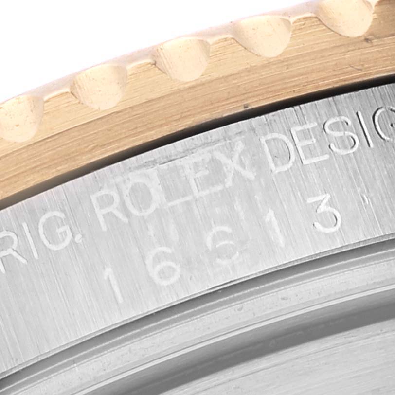 This close-up of the Rolex Submariner 16613 Men's Steel and Gold (two tone) Blue Dial 16613 Men's Steel and Gold (two tone) Blue Dial shows the bezel edge and part of the engraved case back.