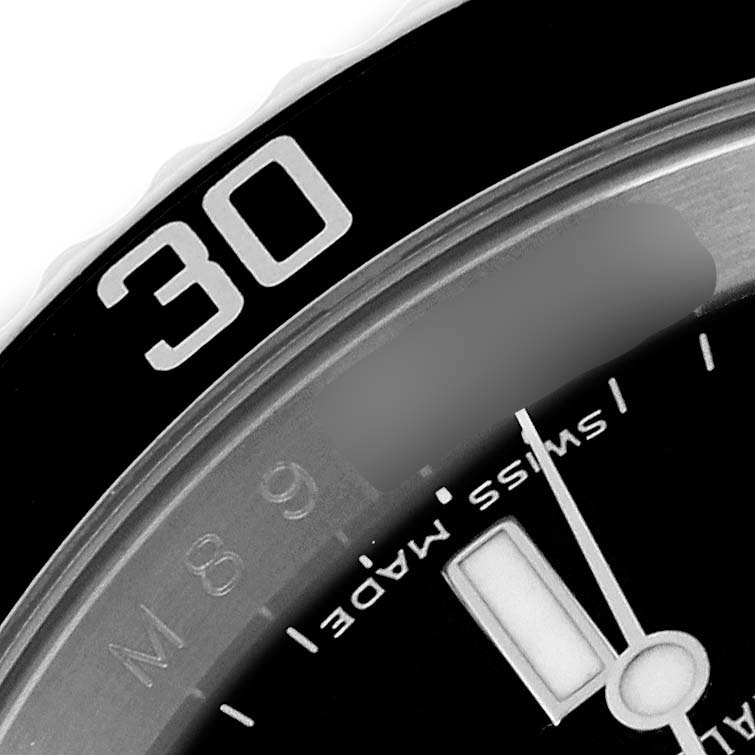 This close-up angle shows part of the bezel and dial of a Rolex Submariner 16610 Men
s Stainless Steel Black Dial 16610 Men
s Stainless Steel Black Dial watch, including the "30" marker and "Swiss Made" text.