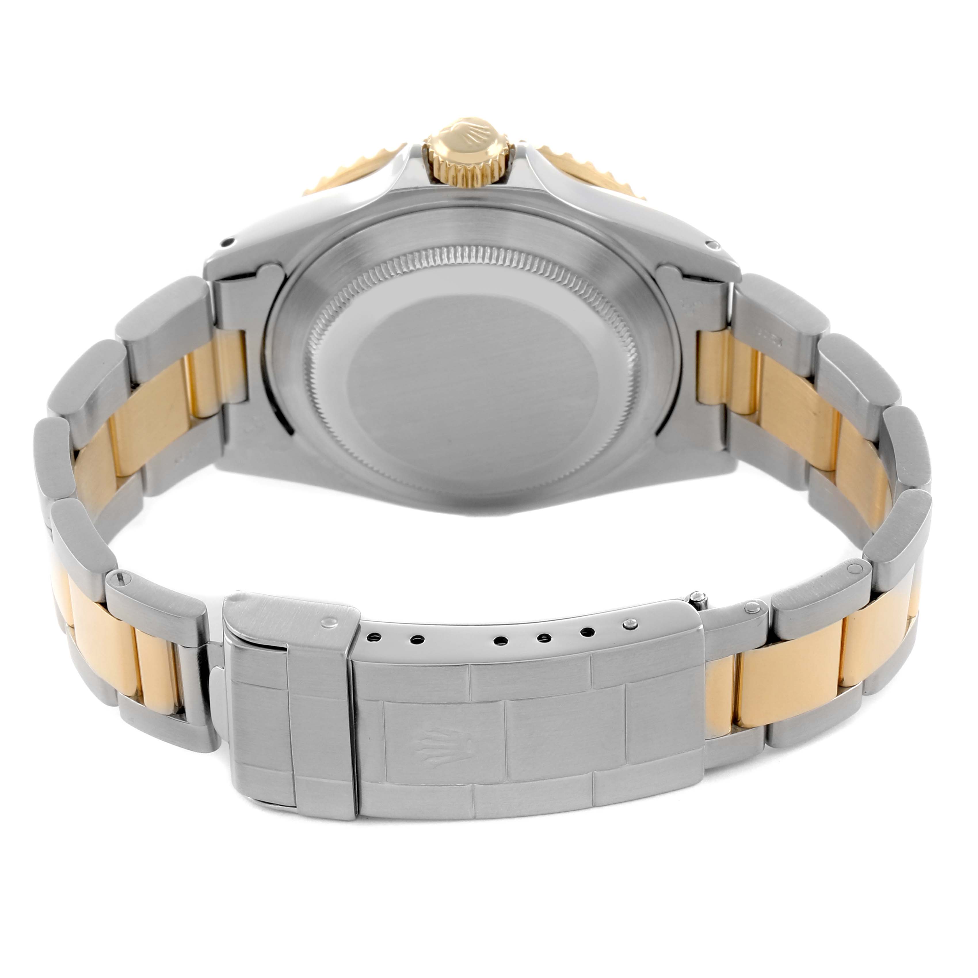 The image shows the back of a Rolex Submariner 16613 Men
s Steel and Gold (two tone) Blue Dial watch, highlighting the clasp and bracelet in a steel and gold tone.