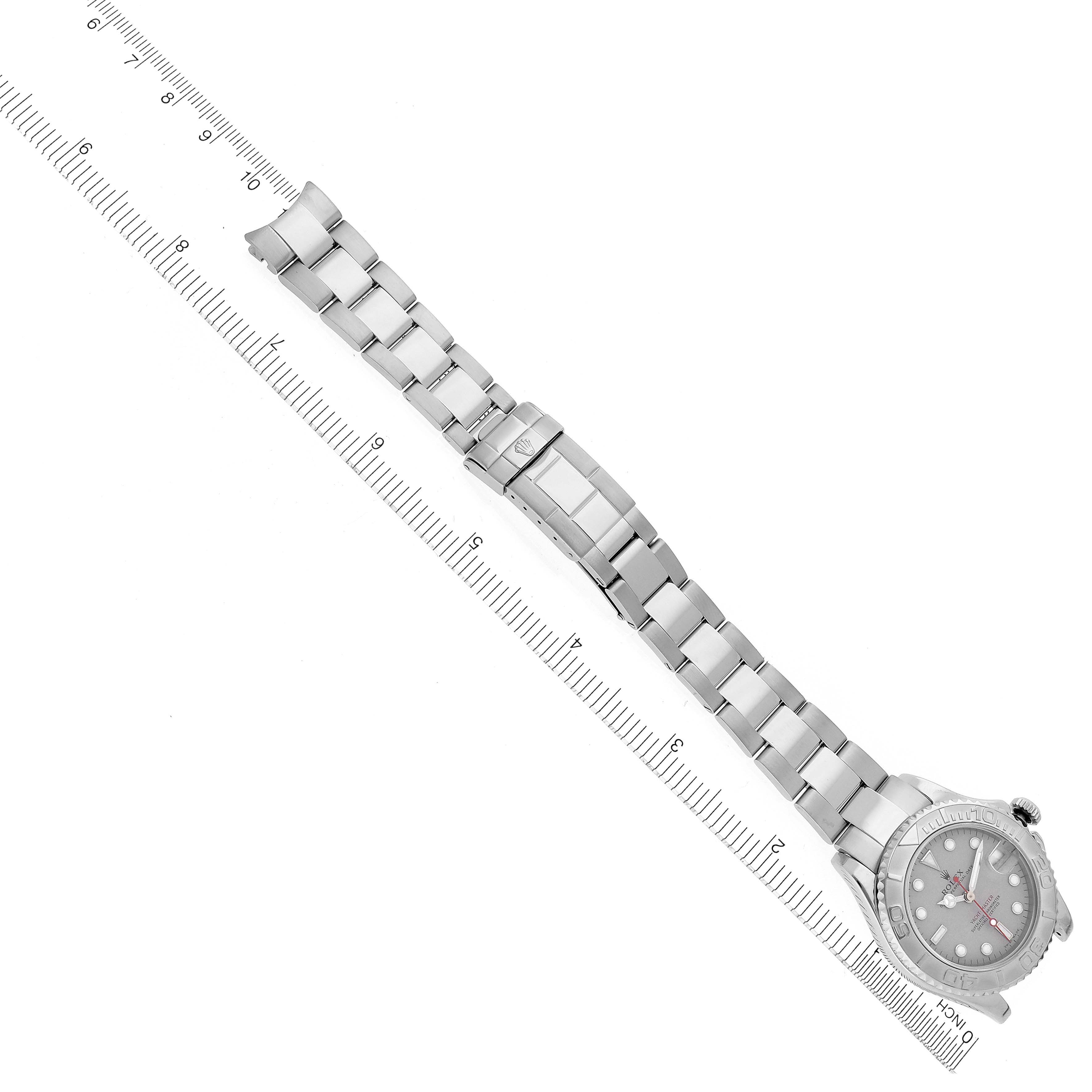 The image shows a top view of a Rolex Yacht-Master 168622 Men's Stainless Steel Grey Dial 168622 Men's Stainless Steel Grey Dial watch, including the face and the full length of the metal bracelet placed against a ruler.