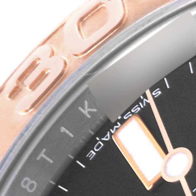 This close-up image shows part of the bezel, dial, and hands of a Rolex Yacht-Master 116621 Men's Steel and Gold (two tone) Black Dial 116621 Men's Steel and Gold (two tone) Black Dial watch.