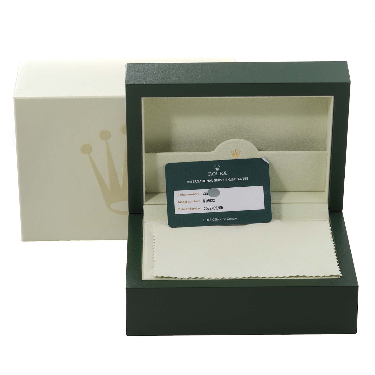 The image shows a Rolex Yacht-Master 16622 Men's Stainless Steel Silver Dial 16622 Men's Stainless Steel Silver Dial watch box with an international service guarantee card and a cleaning cloth inside.