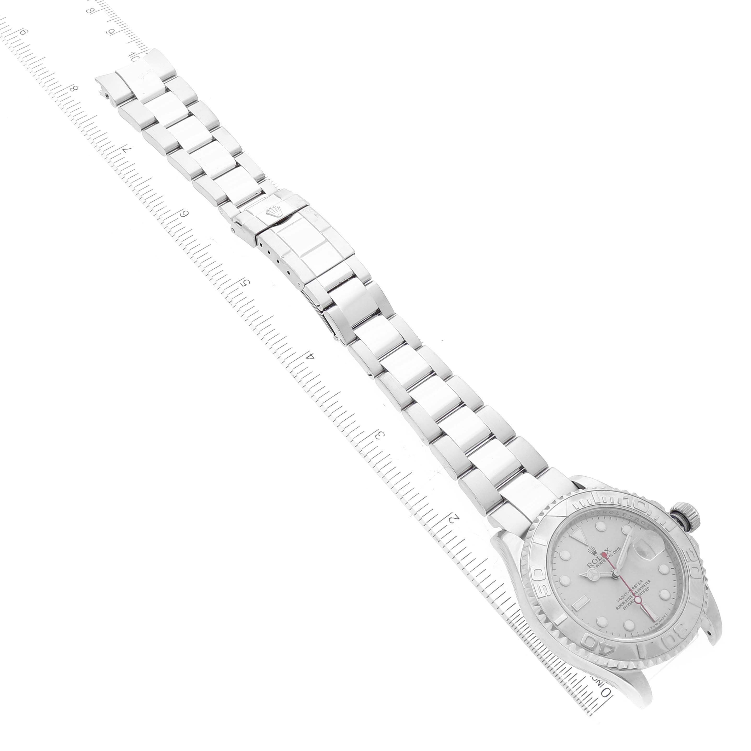 The image shows a top-down view of a Rolex Yacht-Master 16622 Men's Stainless Steel Silver Dial 16622 Men's Stainless Steel Silver Dial watch with its entire bracelet and clasp displayed alongside a ruler.