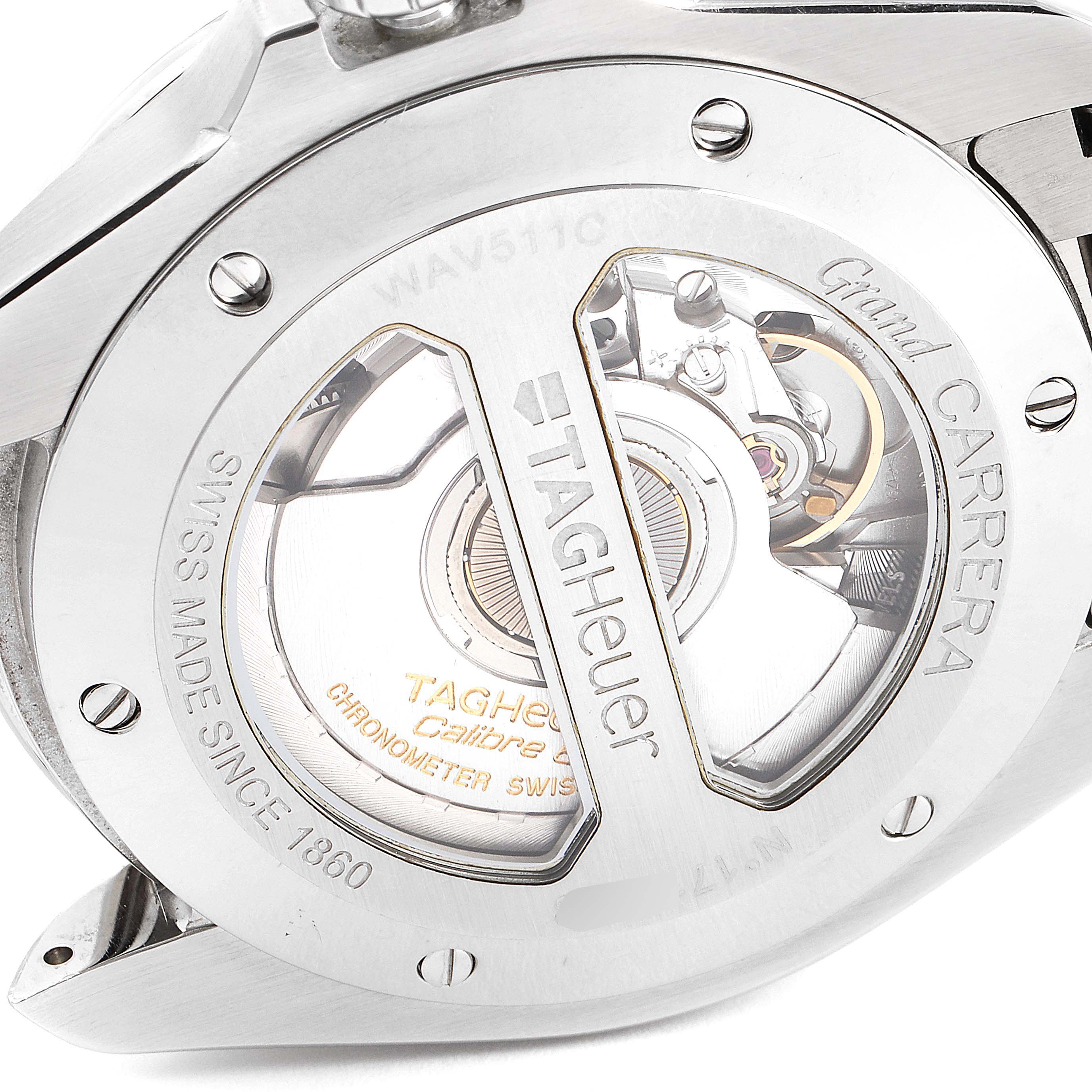 This image shows the back view of the Tag Heuer Carrera WAV511C.BA0900 Men's Stainless Steel Brown Dial WAV511C.BA0900 Men's Stainless Steel Brown Dial watch, highlighting the intricate movement and "Grand Carrera" engraving.