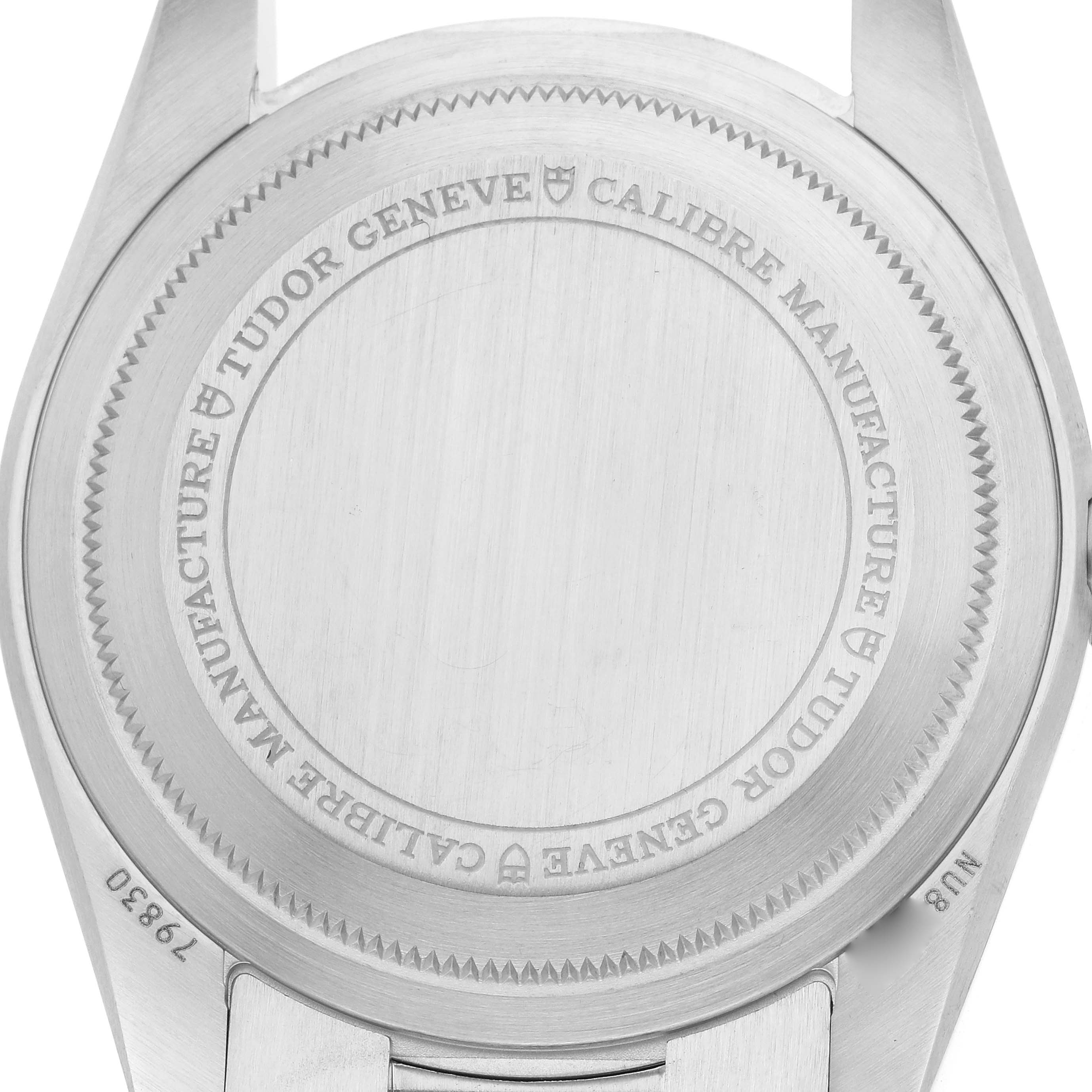 The image shows the back case of a Tudor Heritage Black Bay 79830RB Men
s Stainless Steel Black Dial watch, with engraving details visible.