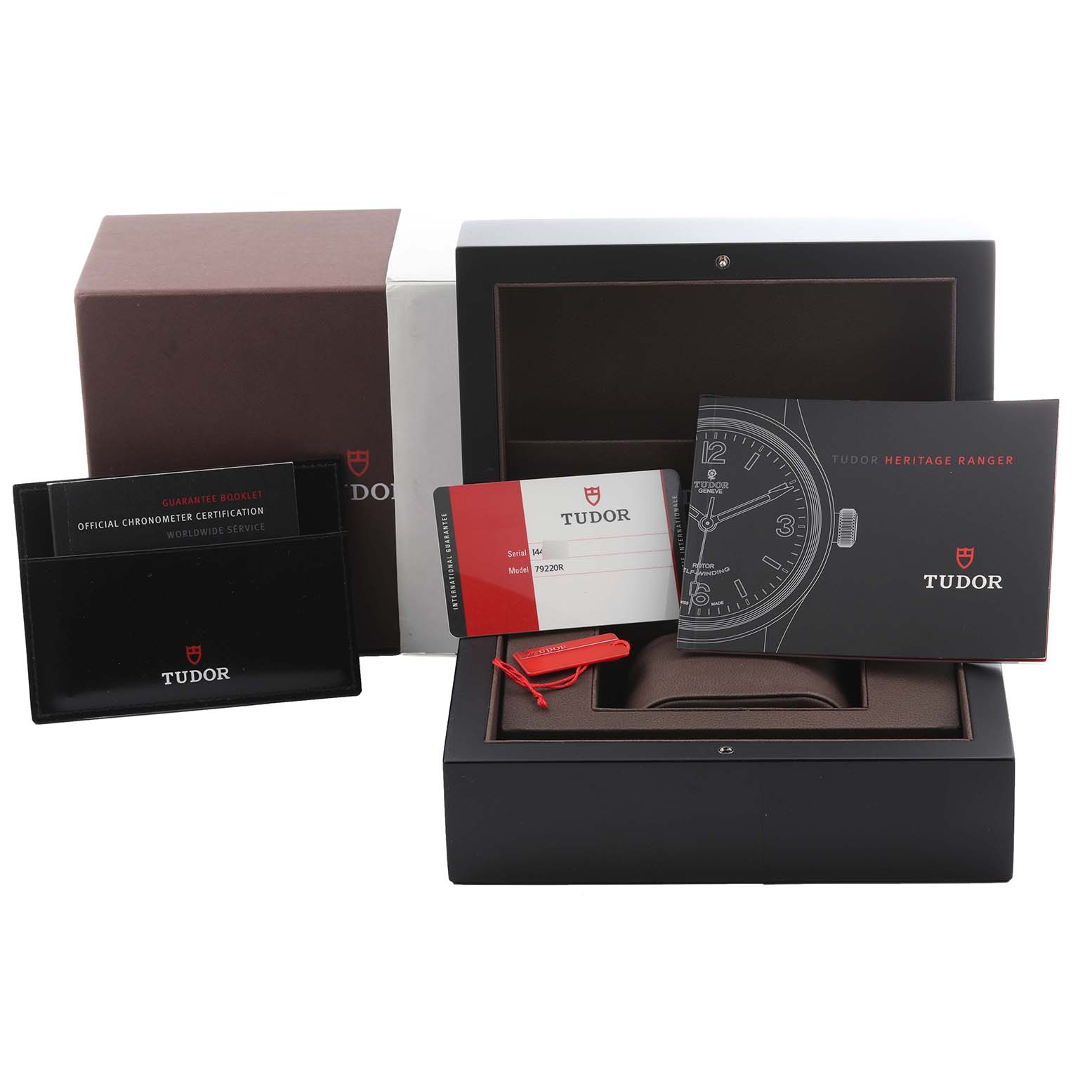 The image shows the packaging, booklets, and tags for a Tudor Heritage Black Bay 79220R Men's Stainless Steel Black Dial 79220R Men's Stainless Steel Black Dial watch, including the warranty card.