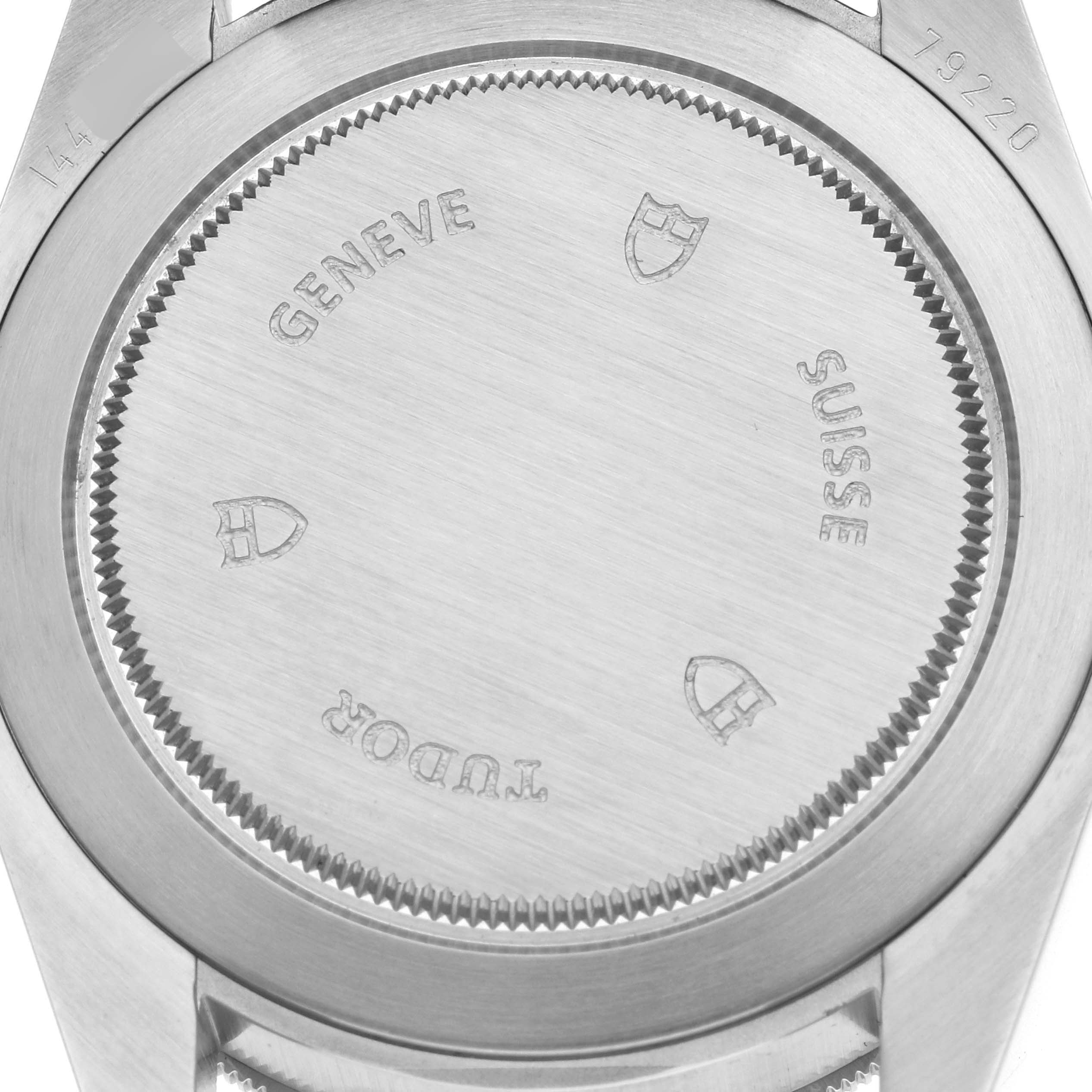 This image shows the back case of the Tudor Heritage Black Bay 79220R Men's Stainless Steel Black Dial 79220R Men's Stainless Steel Black Dial watch, displaying engravings and a brushed metal finish.